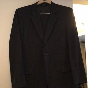 Jos A Bank. Men’s black suit, subtle pinstripe.